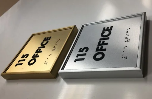 ADA room sign with raised letters and braille