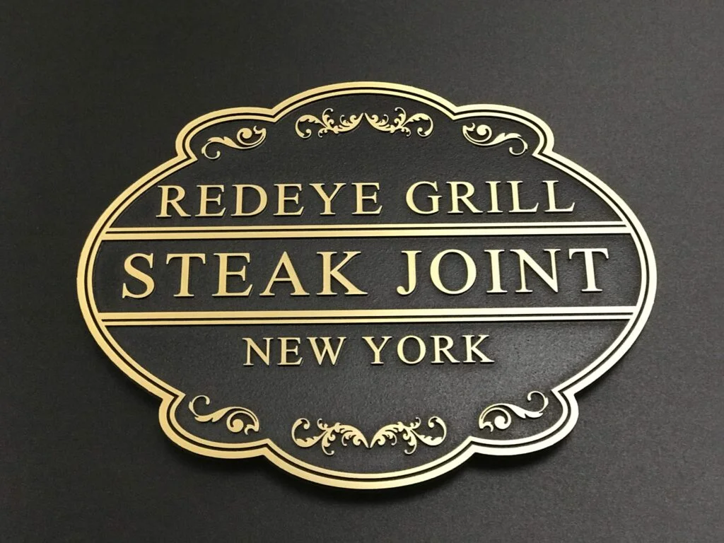 Cast metal plaque with raised lettering and a decorative border for Redeye Grill, New York