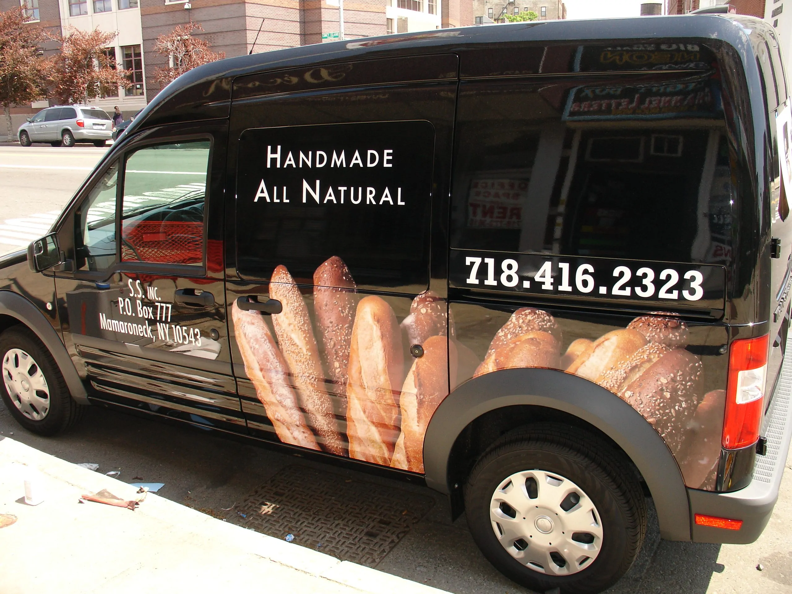 Black delivery van with bread photography and handmade all natural lettering wrapped on the side