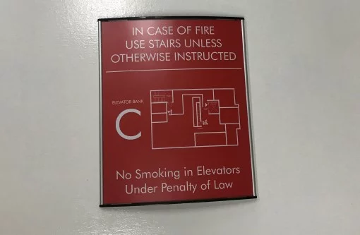 A framed egress map posted on a building floor
