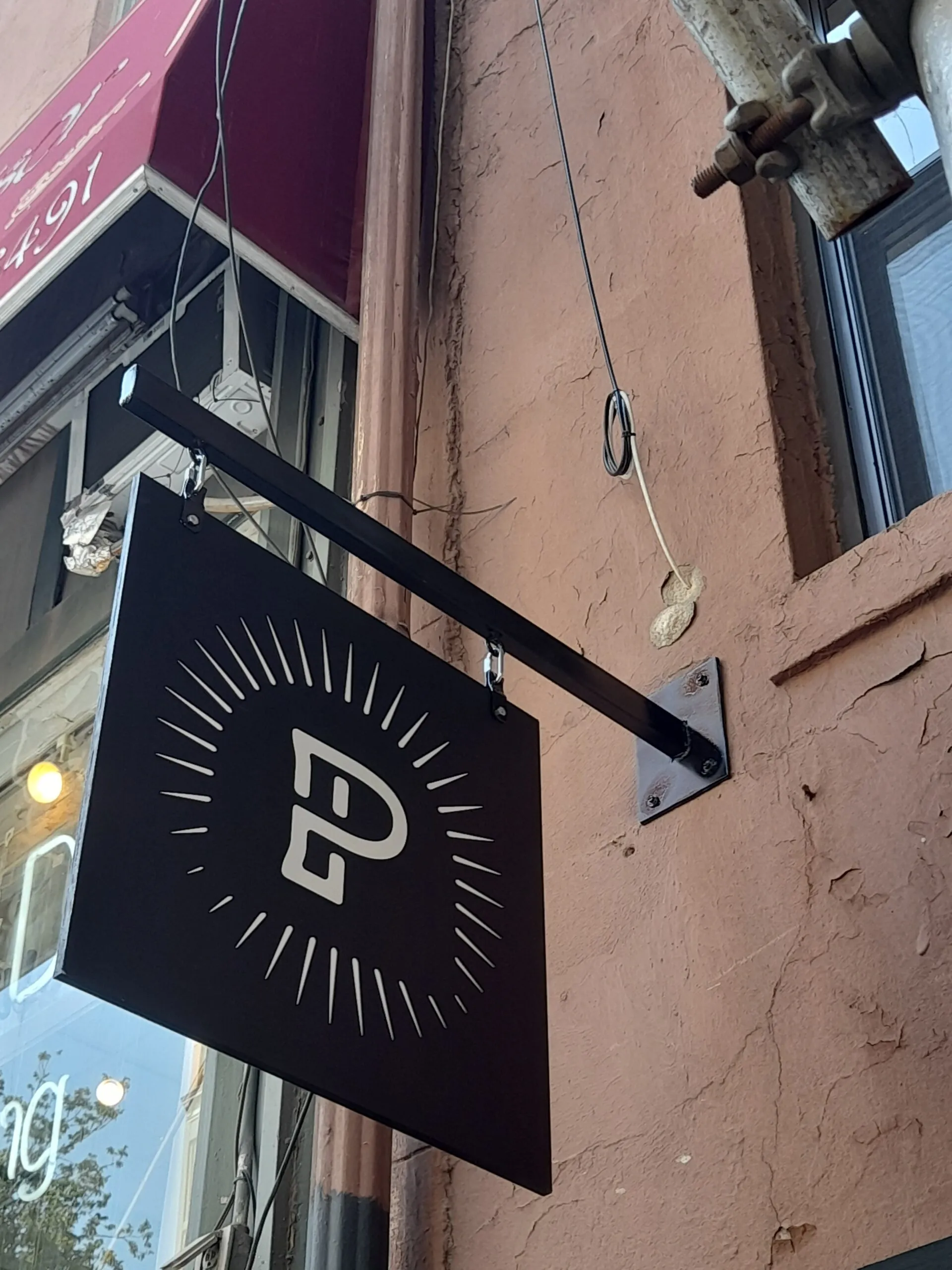 Blade sign installed to its approved projection and clearance