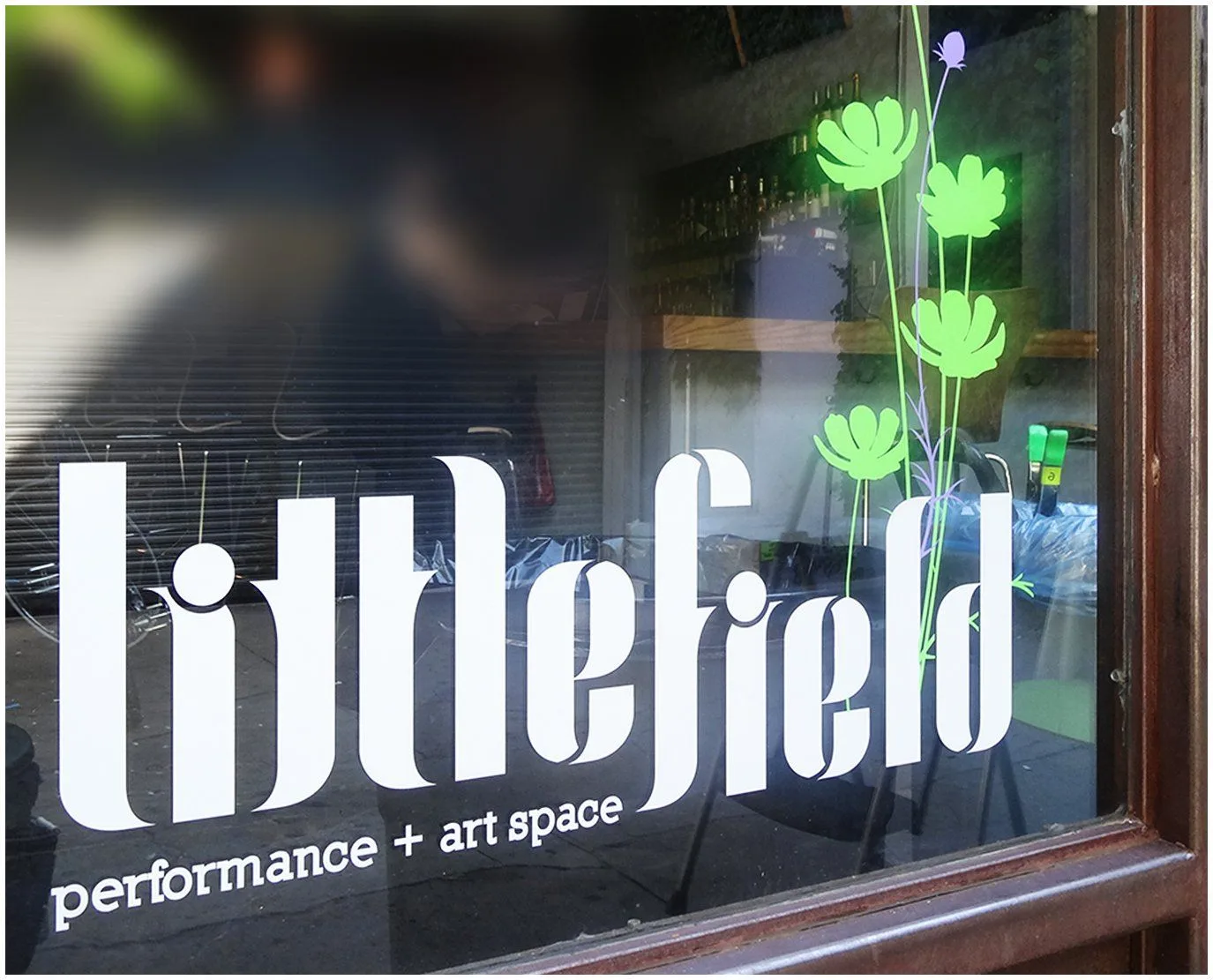 Bold silver leaf window lettering for an art space with clear, heavy strokes