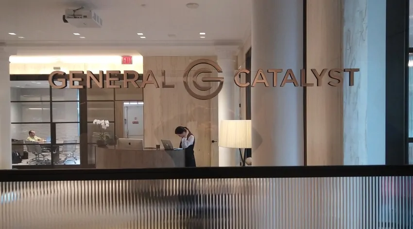 Brushed metal General Catalyst logo letters on a lobby wall above a reception desk