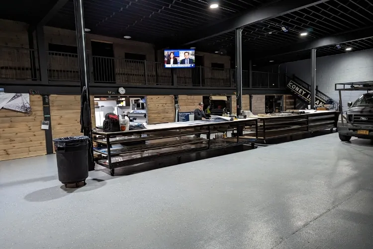 Interior of a sign production shop with fabrication tables and equipment