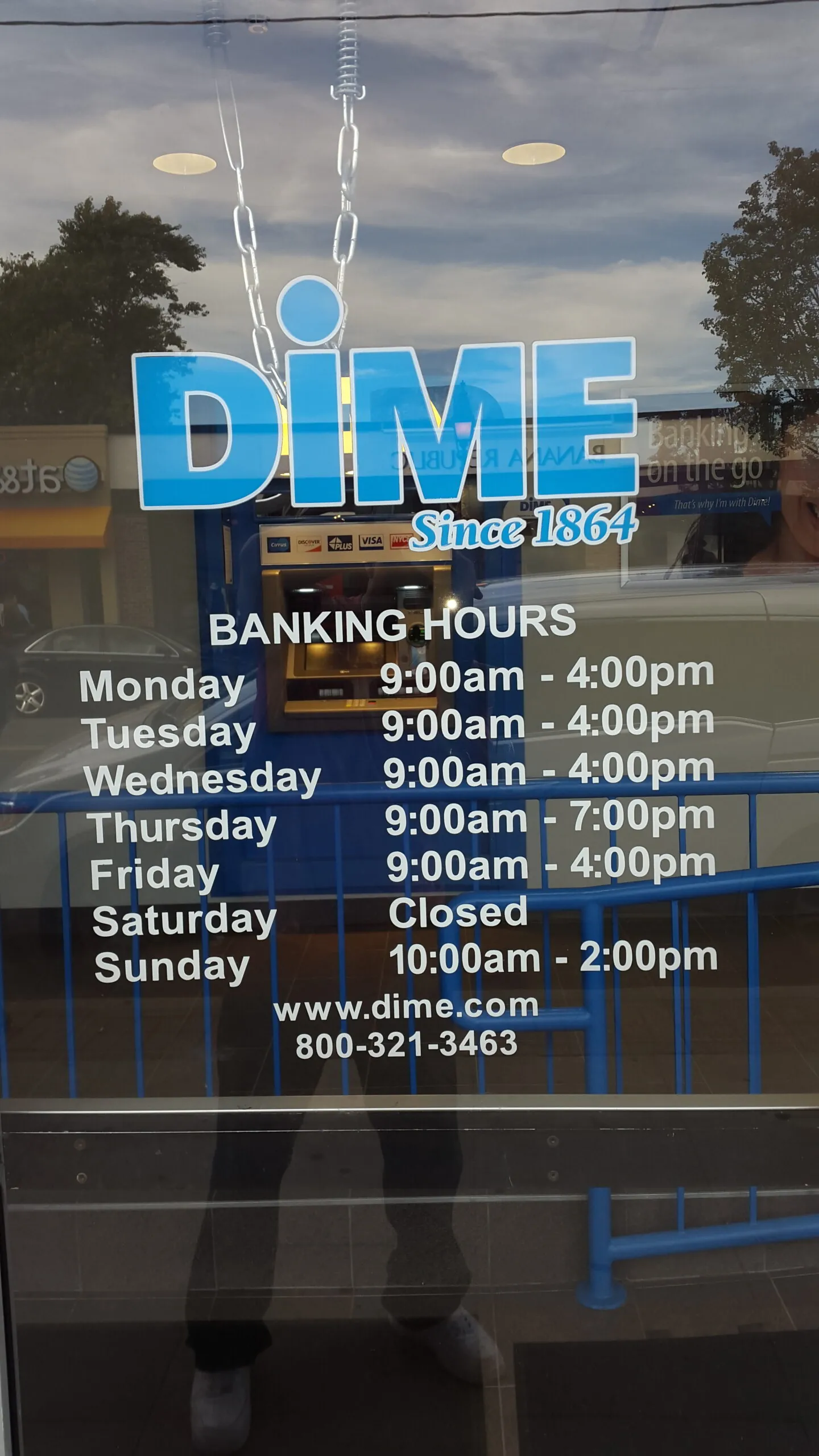 Blue Dime logo and banking hours lettered in vinyl on a glass entrance door
