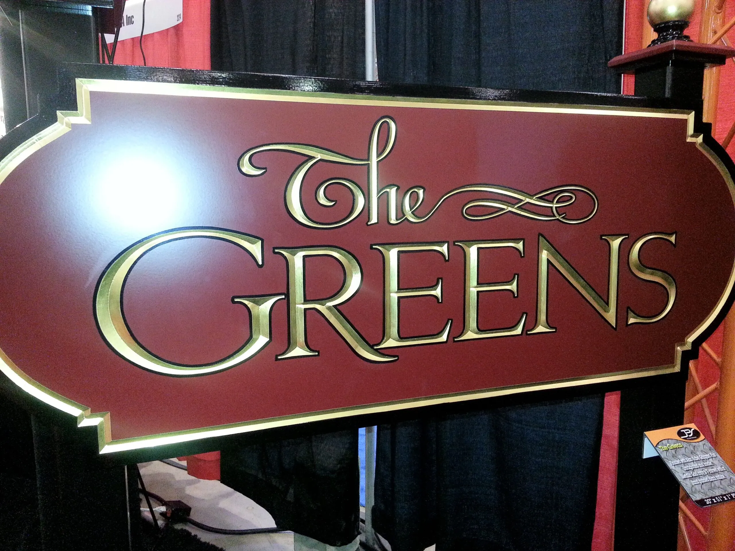 carved sign for the greens