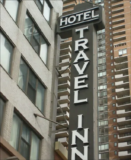 Vertically stacked channel letters on a building corner reading from both directions