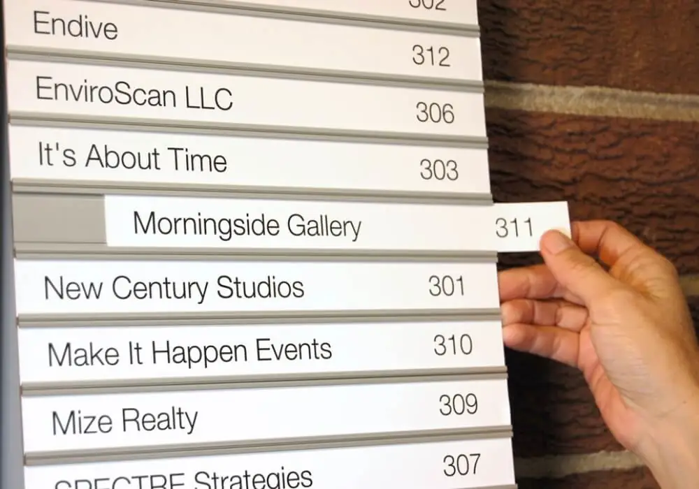 Tenant directory with slide out name strips and suite numbers being updated by hand