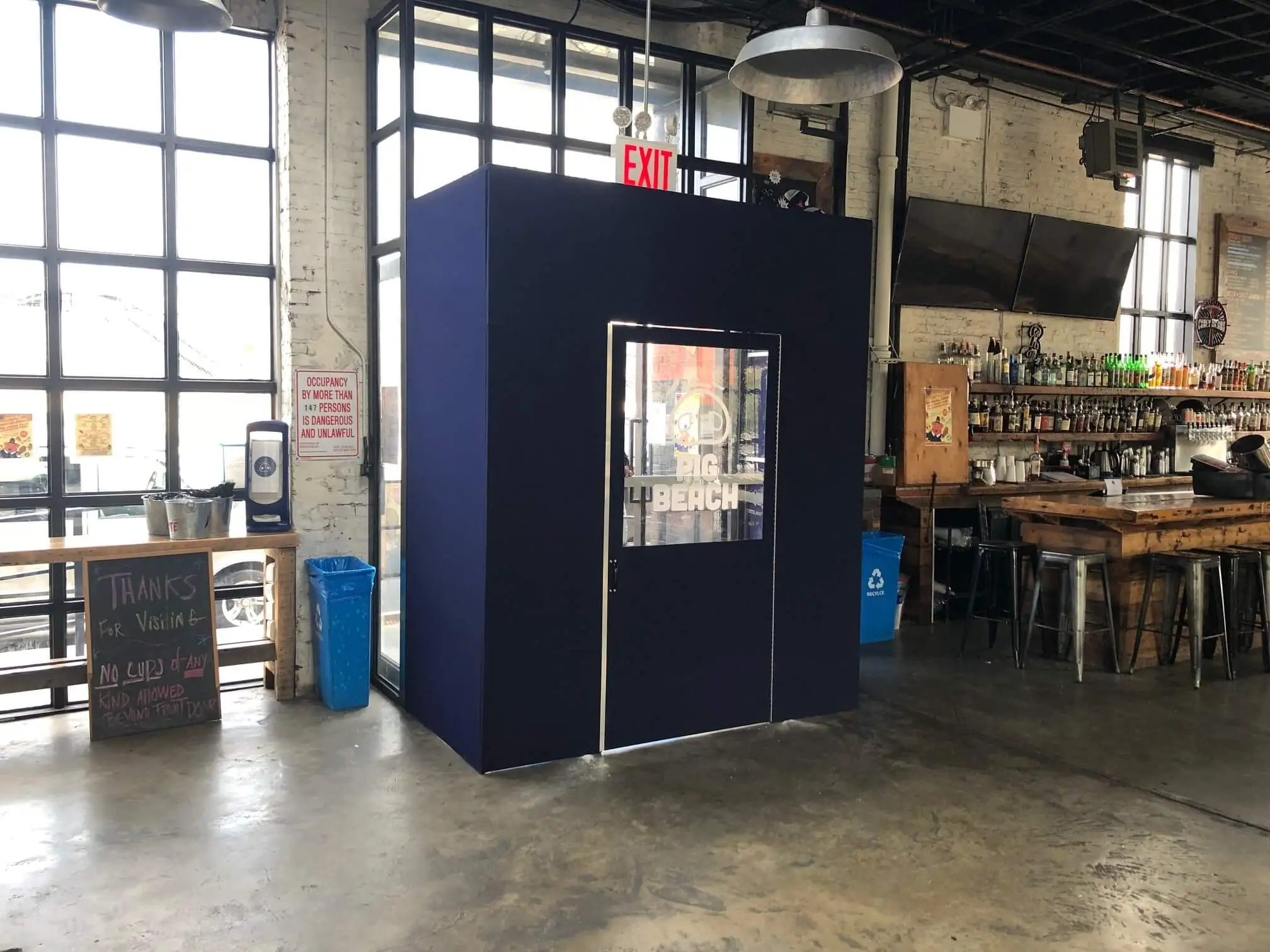 Navy blue entrance vestibule with a glass door installed inside a restaurant