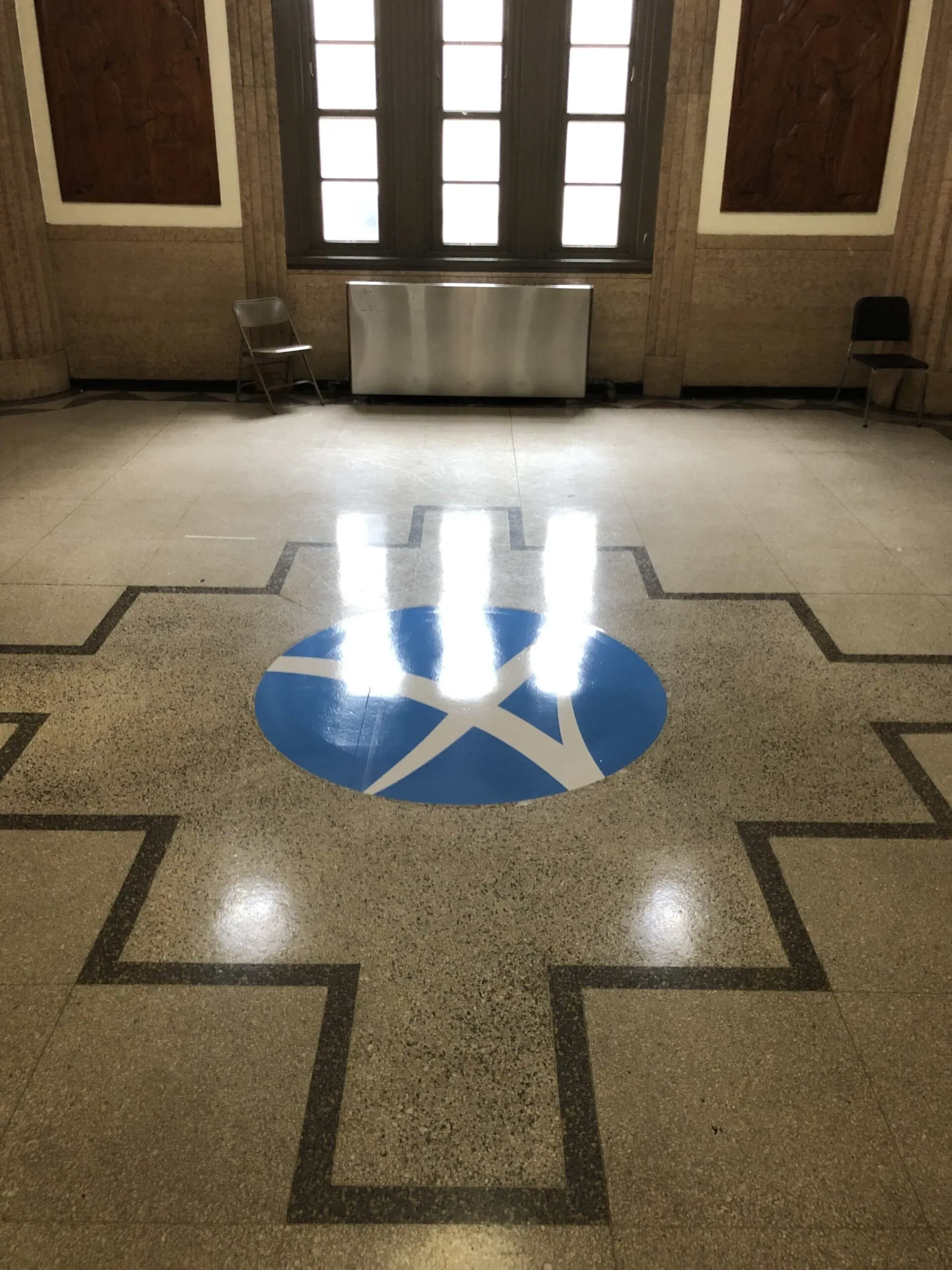 Branded floor graphic used to mark a feature area inside a commercial space