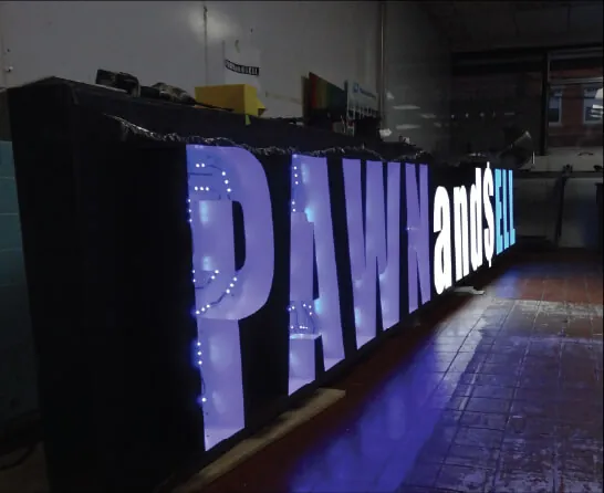 Large front lit channel letters glowing white at night