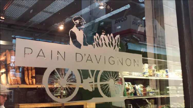 Etched window graphic for Pain D'Avignon bakery that keeps the view into the store open