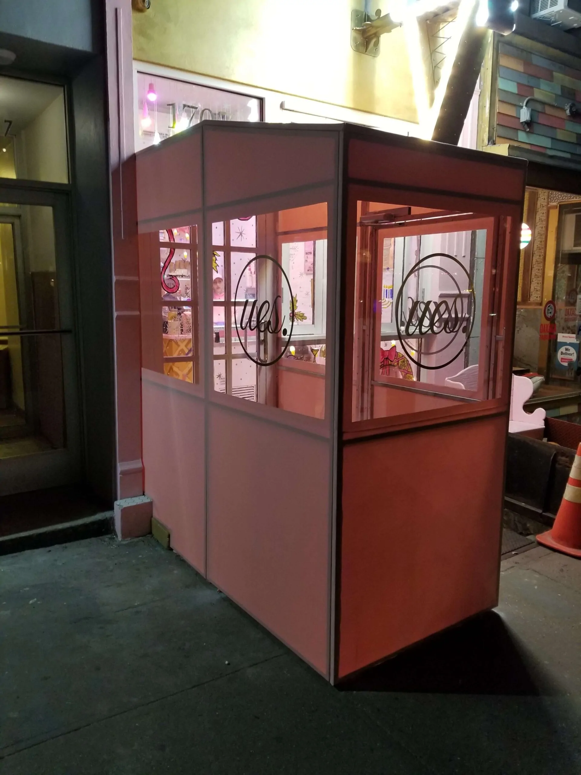 Salon entrance vestibule with frosted logo graphics on the glass panels