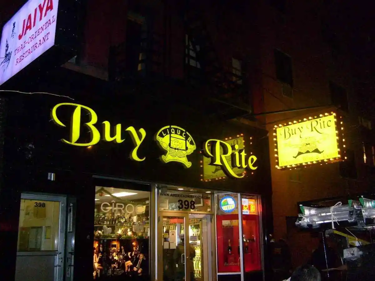 Lit marquee sign on a storefront at night