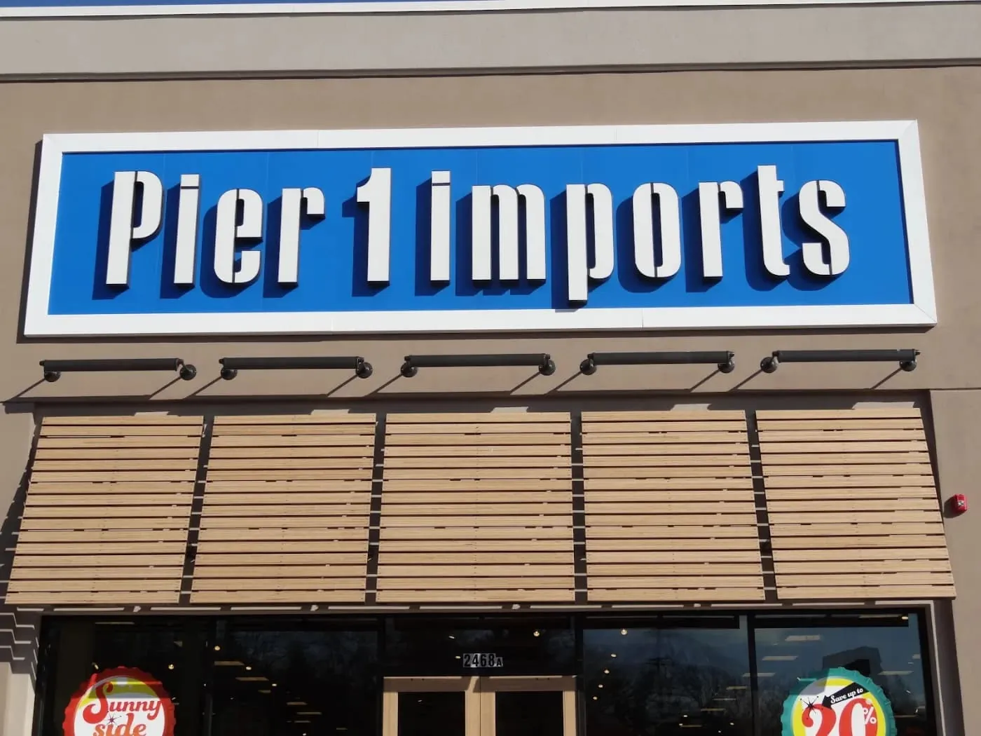 Lit individual letters on a retail storefront fascia with a window display below