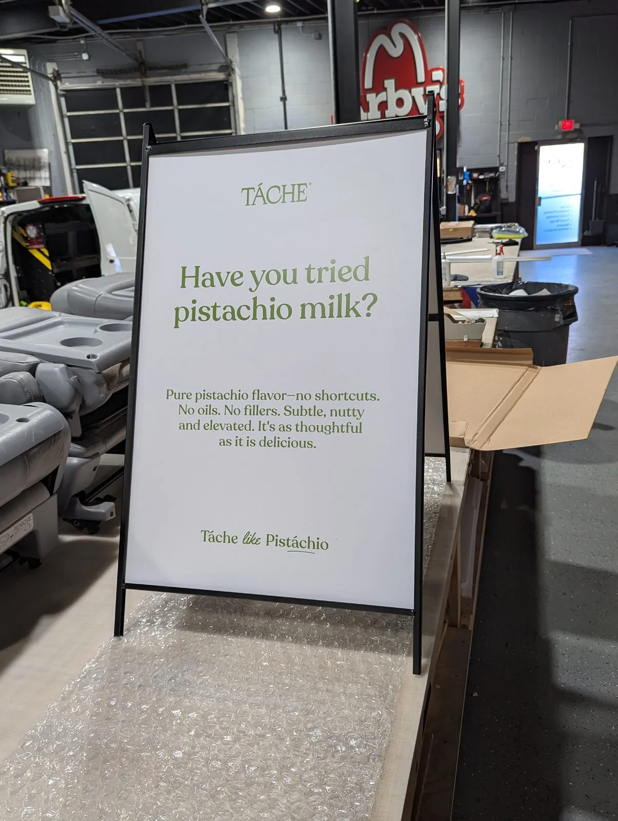 White A frame face asking Have you tried pistachio milk in green type
