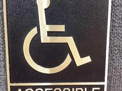 Accessible symbol sign with gold pictogram