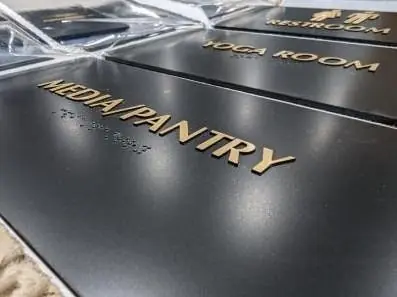 ADA room signs with gold letters in the shop