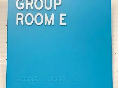 Blue ADA room sign