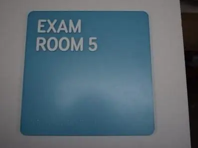 Teal exam room ADA sign