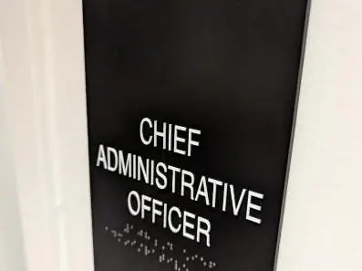Matte black ADA sign with white letters