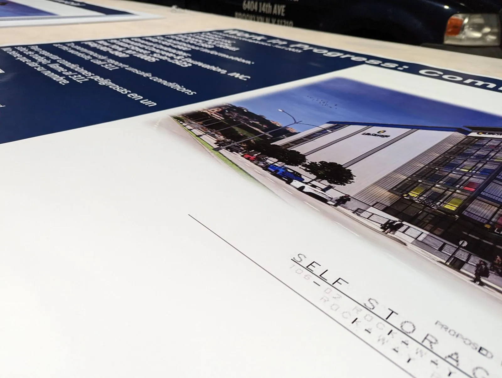 Printed project board with a building photo on the shop table