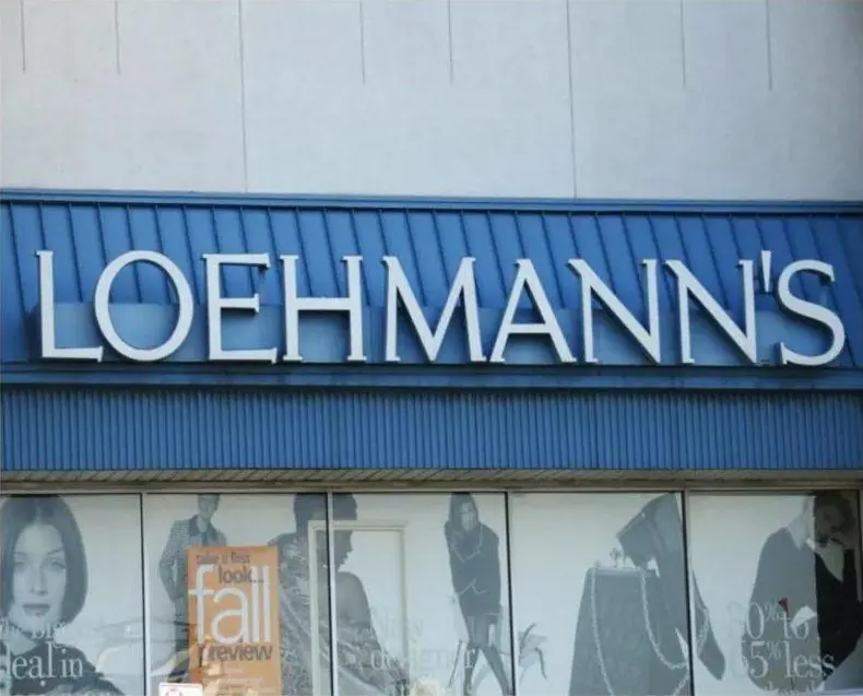 White channel letters spelling Loehmann's on a blue storefront fascia above retail windows