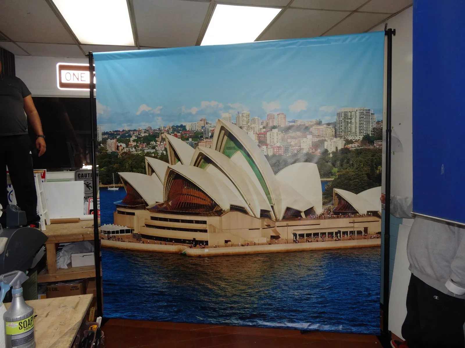 Backdrop printed with the Sydney Opera House and harbor, standing on a frame in our shop