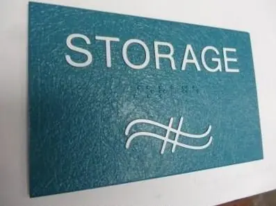 Textured teal storage ADA sign