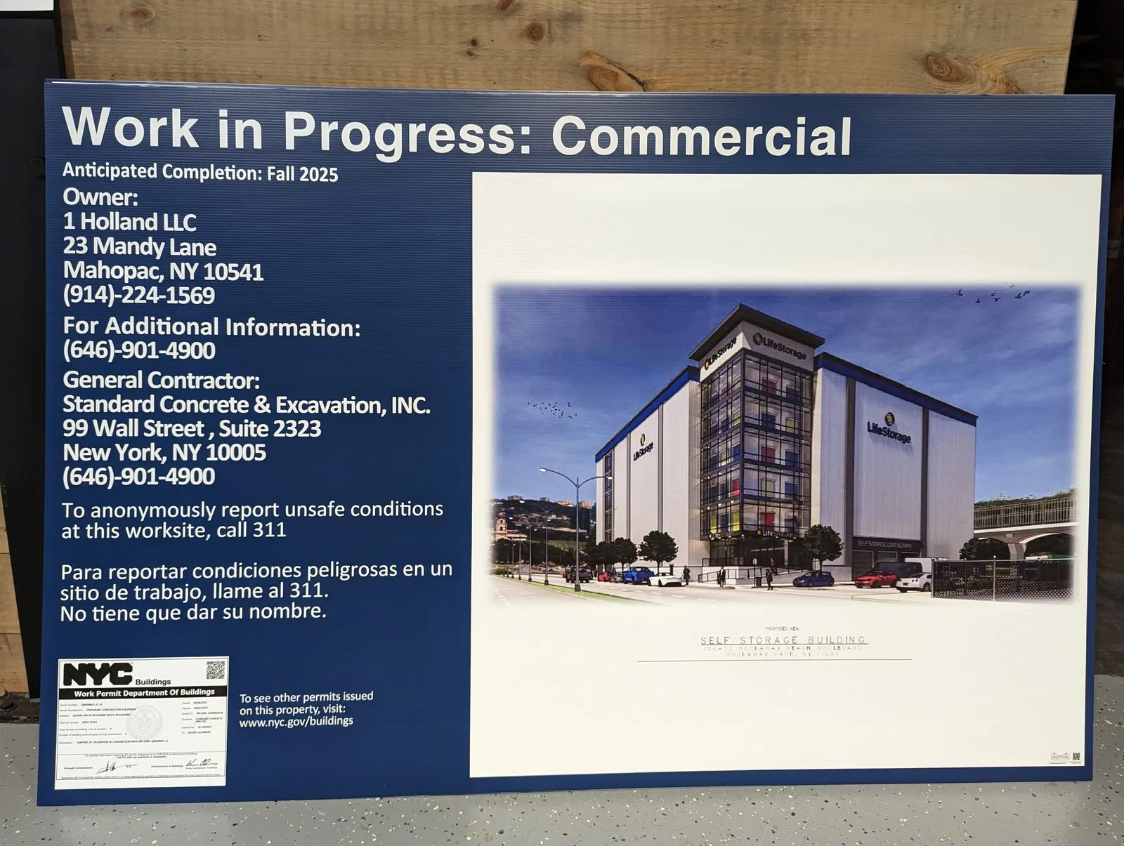Navy Work in Progress commercial board with owner and contractor details and a photo of the finished building
